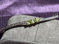 Full view of hinged bangle on display pillow