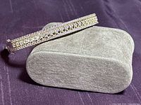 Full bracelet displayed on cushion, showing entire length and clasp