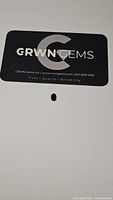Photo of GRWN Gems brand card with gemstone for scale and branding