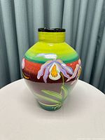 Front view of the pot showing vibrant colors and floral design