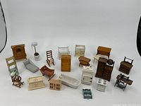 Full group of 22 dollhouse furniture items arranged on white background