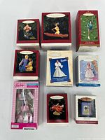 Group of nine boxed Christmas ornaments including Barbie themed and classic holiday designs