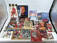 Overview of memorabilia collection showing various Joe Montana and 49ers themed items including books, magazines, cards, and sports collectibles