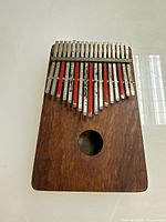 Top view of wooden kalimba with metal tines and sound hole