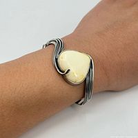 Bracelet worn on wrist showing size, stone color and hinge design