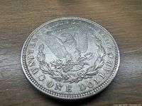 Reverse of 1921 Morgan silver dollar showing eagle design and denomination