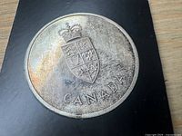 Silver Centennial medal obverse with coat of arms