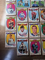First photo shows twelve 1971-72 O-Pee-Chee base cards including Maple Leafs, Bruins, Red Wings, Kings, Canadiens and Black Hawks players