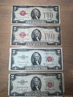 Fronts of four $2 red seal notes showing series and seals