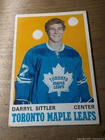 Front of Darryl Sittler O-Pee-Chee rookie card showing player portrait and text