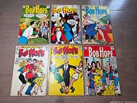 All six comics laid out, covers visible