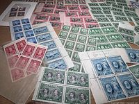 Overall view of assorted Canadian mint stamp blocks spread on table
