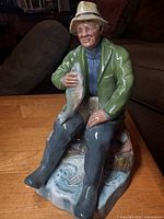 Front view of figurine showing full fisherman pose and colours