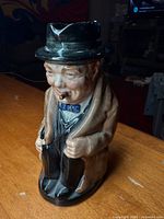 Front view of Royal Doulton Winston Churchill character pitcher standing on table