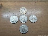 Obverse view of all five Franklin half dollars showing Benjamin Franklin portraits and dates