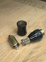 Lighter disassembled showing brass mechanism and base