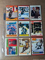Binder page holding nine Wayne Gretzky O-Pee-Chee cards