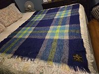 Vintage mohair wool plaid blanket spread on bed showing full pattern and color scheme