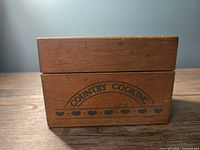 Front view of wooden recipe box stamped 'Country Cooking' with heart decorations.