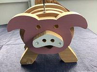 Front view showing pig face, entry holes, slat construction