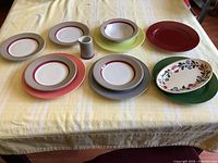 Front view of assorted plates, bowl, pitcher and platter