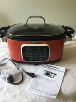 Multi-cooker with lid, power cord and manual