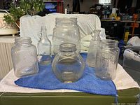 Group shot of six clear glass jars on towel