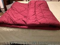 Comforter folded on bed showing thickness and color