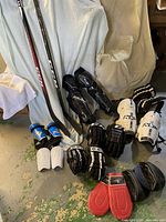 Full lot showing sticks, pads, gloves, push-up discs and shin guards