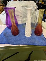 Front view showing six assorted vases on blue towel