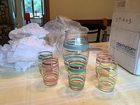 Pitcher with five matching tumblers on table