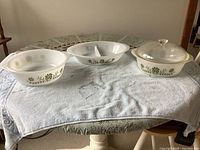 Three Glasbake dishes with lid displayed on table