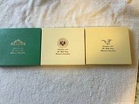 Three closed ornament boxes labeled 1995, 1996, 1997