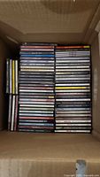 Box containing two tall stacks of CDs