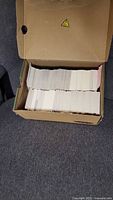 Open cardboard box showing large quantity of stacked hockey trading cards