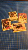 Group shot of all four Ray Bourque cards on grid background
