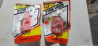 Photo showing two Pink Lady diving sinkers in original yellow, white, red, and black packaging by Wagner&Sons Inc.