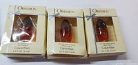 Photo of three boxed 15 ml Calvin Klein Obsession Eau de Parfum sprays showing original packaging and products.