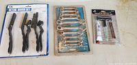 Three new packages of tools: a 6-piece detail brush set, a 10-piece wrench set, and a tire repair kit with adhesive and tools.