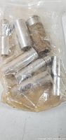 Photo of seven chrome deep sockets inside a clear plastic bag showing condition and quantity