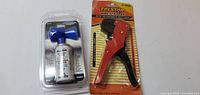 Photo of two tools: a horn air duster and a wire stripper, both new in packaging.