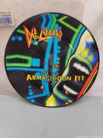 Picture side of Def Leppard Armageddon It 7" picture disc