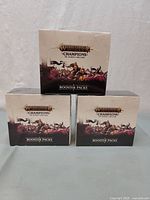 Three sealed booster boxes stacked