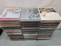 Three columns of stacked jewel-case CDs showing overall quantity