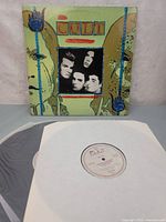 Front of gatefold sleeve standing behind record