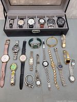 Group shot showing all 18 watches and storage case
