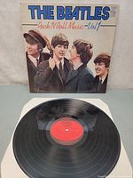 Front cover of LP showing title and group photo, record displayed beneath