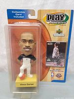 Front view of sealed package showing bobblehead and card