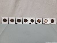 Eight coins in flips labeled 1901-1908