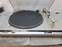 Front view of Technics SL-B20 turntable showing platter, mat, controls, and tonearm